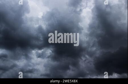 Dark stormy sky with grey clouds background. Stock Photo