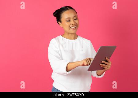 Modern Technologies. Portrait Of Young Smiling Asian Female Using Digital Tablet Stock Photo