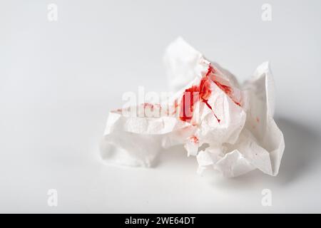 Fresh red blood stained on tissue paper on white table Stock Photo