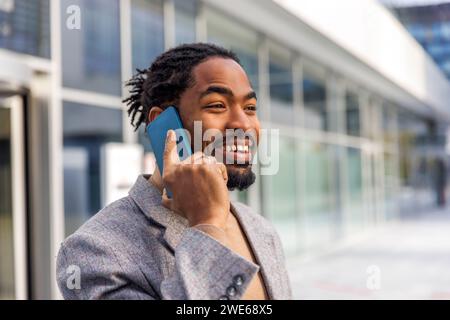Happy businessman with beard talking on smart phone Stock Photo