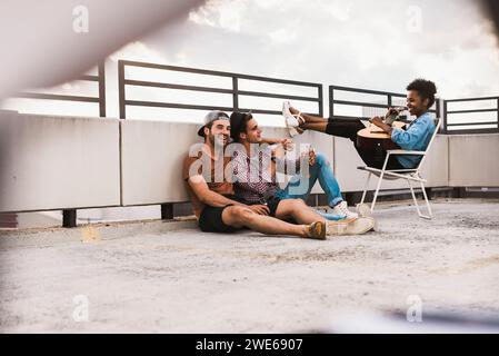 Happy young friends partying and having fun on terrace Stock Photo