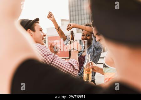 Happy friends enjoying party and dancing on terrace Stock Photo