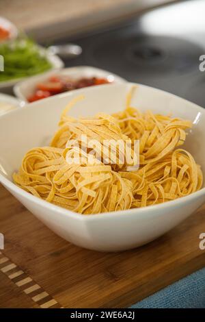 Fresh ribbon noodles in a white bowl Stock Photo