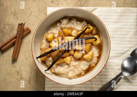 Oatmeal breakfast with cinnamon, caramel apples and vanilla Stock Photo