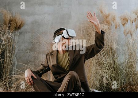 Businessman using virtual reality simulator and gesturing in garden Stock Photo