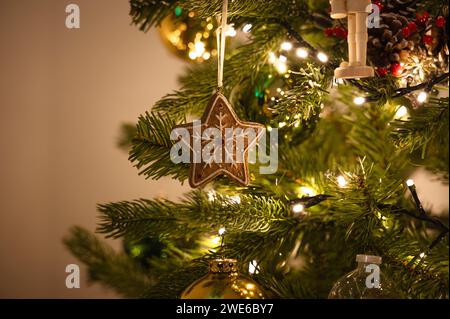 Star shaped ornament hanging on Christmas tree Stock Photo