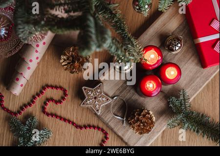 Christmas candles with decoration and gift box on table Stock Photo