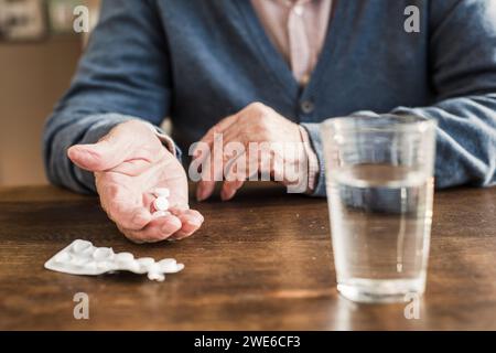 Senior man taking medicines at home Stock Photo