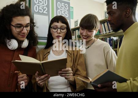 Group of college students studying together in library Stock Photo