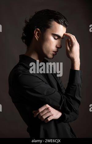 Stressed young man wearing black shirt Stock Photo
