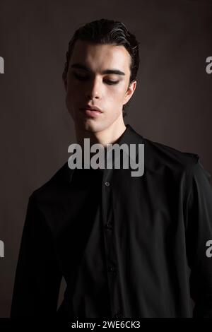 Fashionable man in shirt against black background Stock Photo
