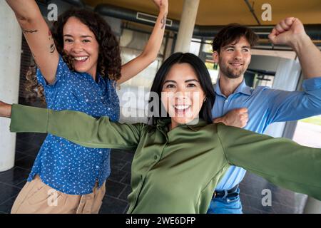 Cheerful multiracial business colleagues dancing in office lobby Stock Photo