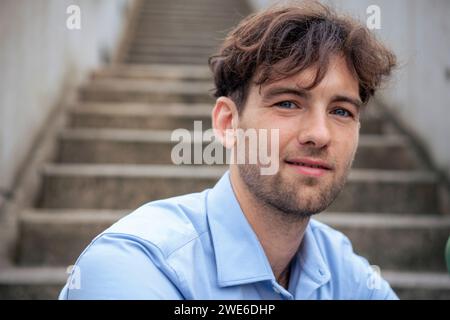 Young handsome man sitting on steps Stock Photo