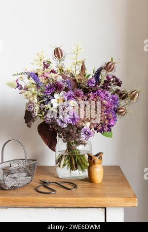 Bouquet of cut flowers on wooden cabinet Stock Photo