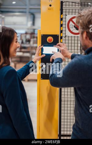 Engineers using control panel standing in industry Stock Photo