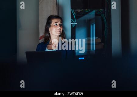 Engineer with laptop working in workshop Stock Photo