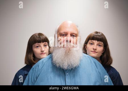 Portrait of father with twin daughters Stock Photo