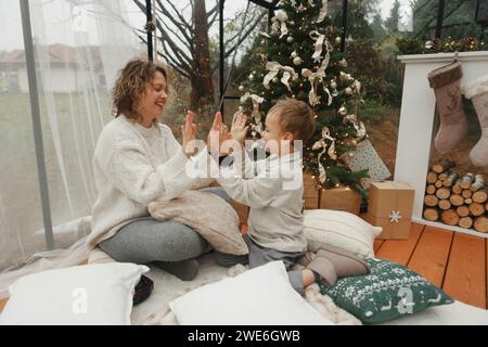 Happy mother and son playing clapping game at home Stock Photo