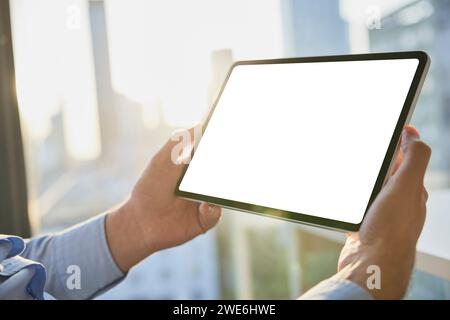 Hands of businessman holding tablet PC with blank screen Stock Photo