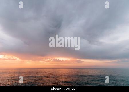 Dramatic clouds over Atlantic Ocean in Asturias, Spain at sunset Stock Photo