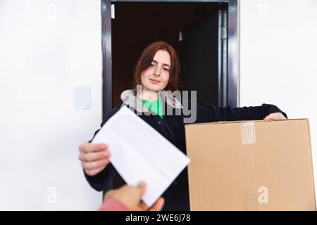 Delivery woman passing receipt to customer Stock Photo