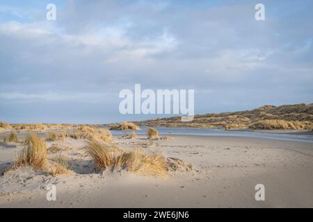 Netherlands, Friesland, Terschelling, Clouds over grassy sand dunes Stock Photo