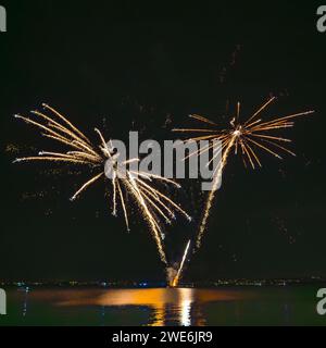 Italy, Veneto, Fireworks exploding over lake Garda at night Stock Photo