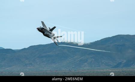 An F-35 Lightning II assigned to the 56th Fighter Wing, performs an aerial maneuver over Barry M. Goldwater Range, Arizona, Jan. 19, 2024. The Barry M. Goldwater range, south of Phoenix, Arizona, is host to a number of air-to-ground bombing ranges which are utilized for training. Luke AFB is the largest fighter wing in the world and home to eight fighter squadrons that train with both the F-35 and F-16 aircraft. (U.S. Air Force photo by Airman 1st Class Elias Carrero) Stock Photo