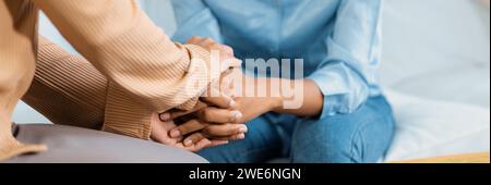 Close up shot of supportive and comforting hands for cheering up depressed patient person or stressed mind with crucial empathy Stock Photo