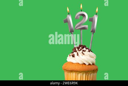 Birthday with number 121 candle and cupcake - Anniversary card on green color background Stock Photo