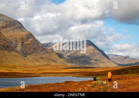 Hikers with a dog travelling along Kungsleden trail in September, Lapland, Sweden Stock Photo