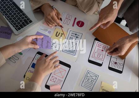 Top view image of a professional and creative UX UI graphic designer team voting a perfect prototype for their new product, discussing and planning wo Stock Photo