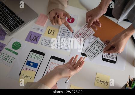 Top view image of a professional and creative UX UI graphic designer team voting a perfect prototype for their new product, discussing and planning wo Stock Photo