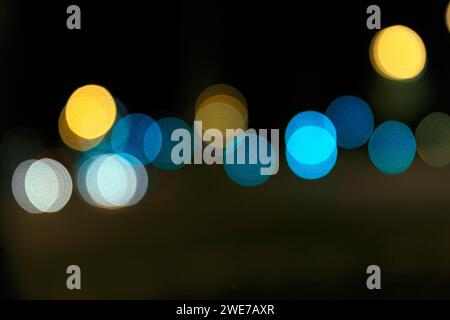 Bokeh balls, abstract dark background with blue and yellow lights, night shot, Barcelona, Spain Stock Photo