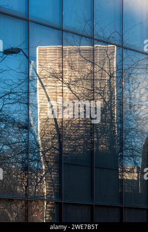 Reflection of an office building in the mirrored facade of another building in Barcelona Stock Photo