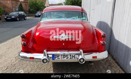 Red classic car parked on a street during the day, with shiny chrome details and historic licence plate, classic car, Buick Eight, Ilsede, Peine Stock Photo