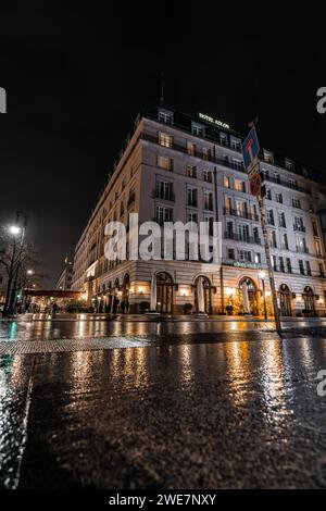 Night view of an elegant hotel with wet streets and atmospheric lighting, Hotel Adlon, Berlin, Germany Stock Photo