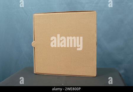 Cardboard boxes on a black table, isolated on a dark background Stock Photo