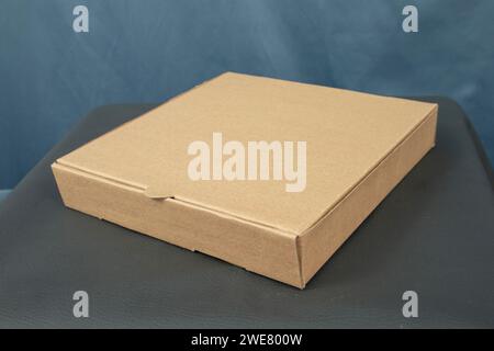 Cardboard boxes on a black table, isolated on a dark background Stock Photo
