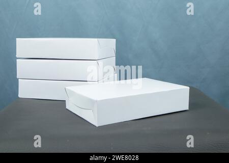 Cardboard boxes on a black table, isolated on a dark background Stock Photo