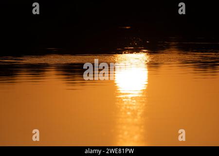 Beautiful view of the reflection of a sunset in the waters of a lake. Stock Photo
