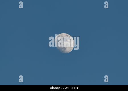 Beautiful view of the waning moon in the blue sky during the day. Stock Photo