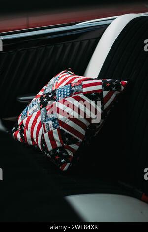 American Flag Patchwork Pillow on back seat interior of classic vintage car from a car rally Stock Photo