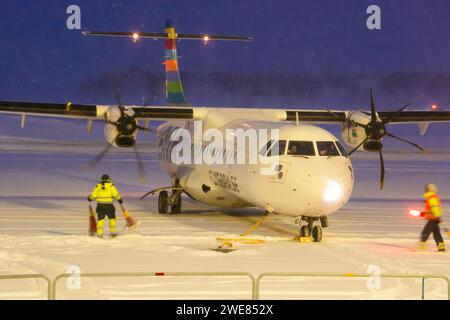 Braathens airline ATR-72-600 aircraft taxiing in heavy snow. Passenger plane in snow at the airport. twin-engine passenger aircraft at night at Umeå Stock Photo