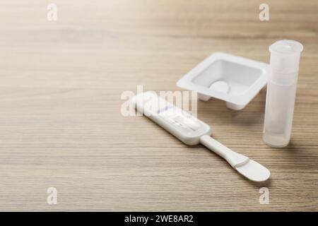 Disposable express test kit on wooden table, closeup. Space for text Stock Photo