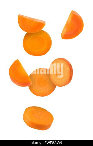 Fresh carrot slices falling on white background Stock Photo