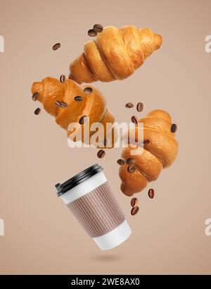 Fresh croissants, aromatic coffee and roasted beans in air on dark beige background Stock Photo