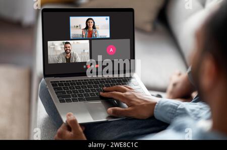 Over shoulder view man have video chat with multiracial people Stock Photo