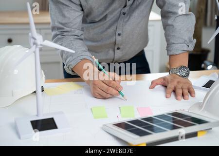 Businessmen with solar panel on desk in office. Stock Photo