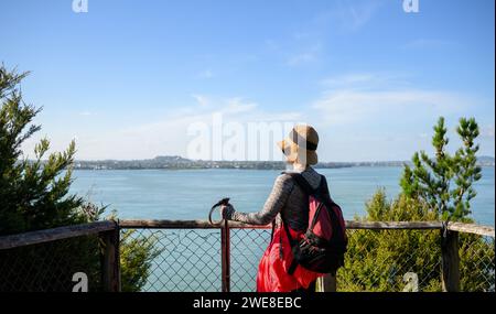 Woman enjoying the view of Waitemata Harbour from Kauri Point Centennial loop track. Auckland. Stock Photo